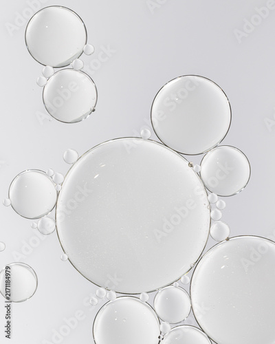 Cosmetic serum with transparent bubbles macro skincare texture on white background