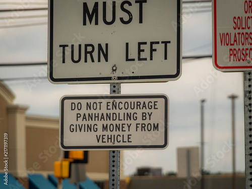 Fotografie A closeup of a must turn left traffic sign combined with a do not encourage panh