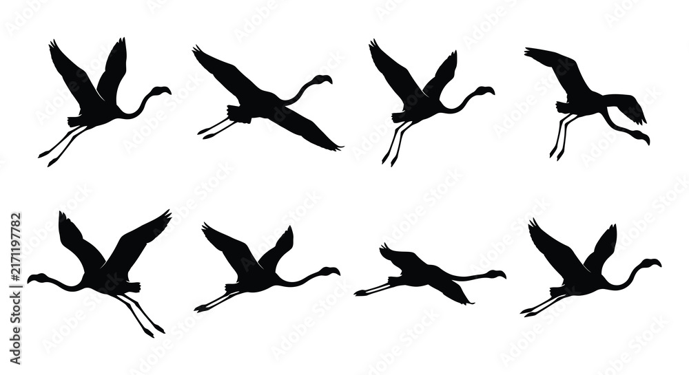 Naklejka premium Black silhouettes of flying cranes depict a dynamic vector illustration