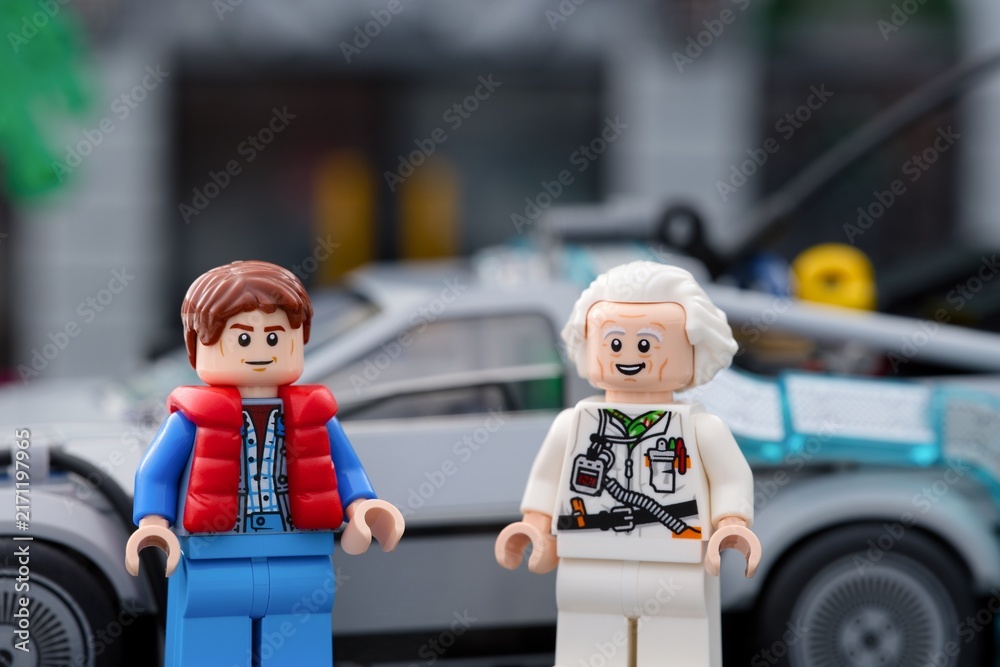 Fototapeta premium Tambov, Russian Federation - July 30, 2026 Lego Marty McFly and Doc Brown minifigures standing in front of the DeLorean time machine car from Back to the Future.