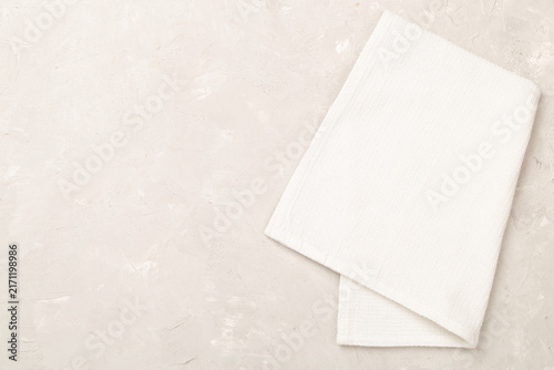 Fotografie Kitchen napkin on concrete background, top view