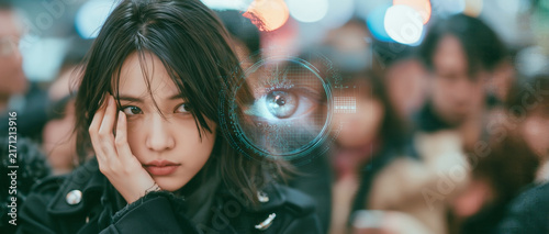 Japanese commuter covering face from holographic AI eye showing facial recognition rejection privacy concern and digital surveillance resistance