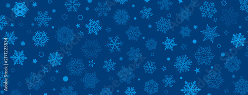 A deep blue Christmas background featuring various stylized snowflakes, stars, and circular elements in lighter shades of blue for a festive winter feel.