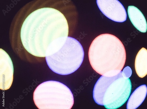 Soft pastel bokeh light background with glowing colorful circular spots