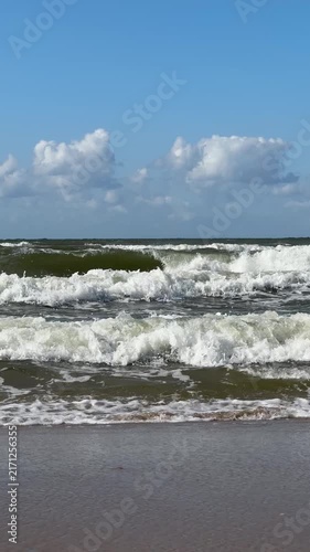 The Baltic Sea in summer, the shore and waves in beautiful, sunny weather.