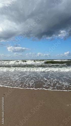 The Baltic Sea in summer, the shore and waves in beautiful, sunny weather.