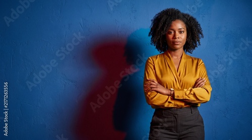 Confident woman framed by red and blue shadows