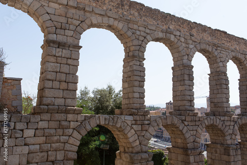 Historic aqueduct with stone arches in Segovia during a sunny day