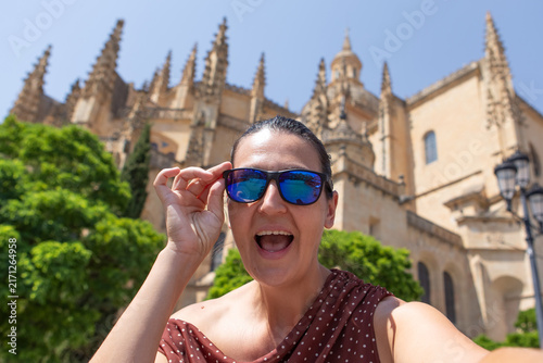 Family member enjoys a selfie in the old town near a stunning building during a vacation