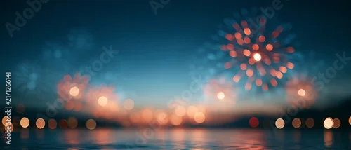 Panel kuchenny z motywem Night sky lit by colorful fireworks reflected in calm water