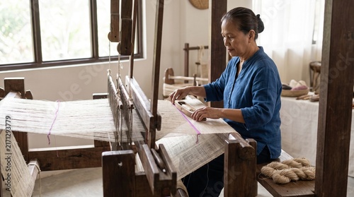 Obraz na płótnie Artisan weaving translucent pineapple cloth on a hand loom