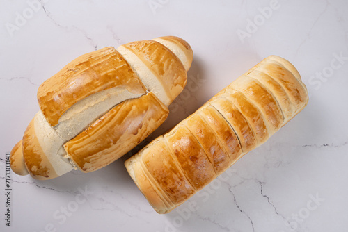 Breads,  beautiful, delicious loaves seen from above on a light, marbled surface, selective focus, top view.