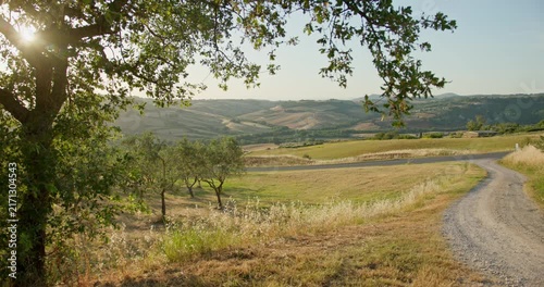 Beautiful tuscan landscape with rolling hills and sunflare