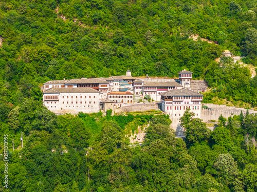 Aerial view of Bigorski Monastery St John the Baptist nestled in lush mountains with stone architecture and terracotta roofs in Rostushe, Municipality of Mavro, North Macedonia.