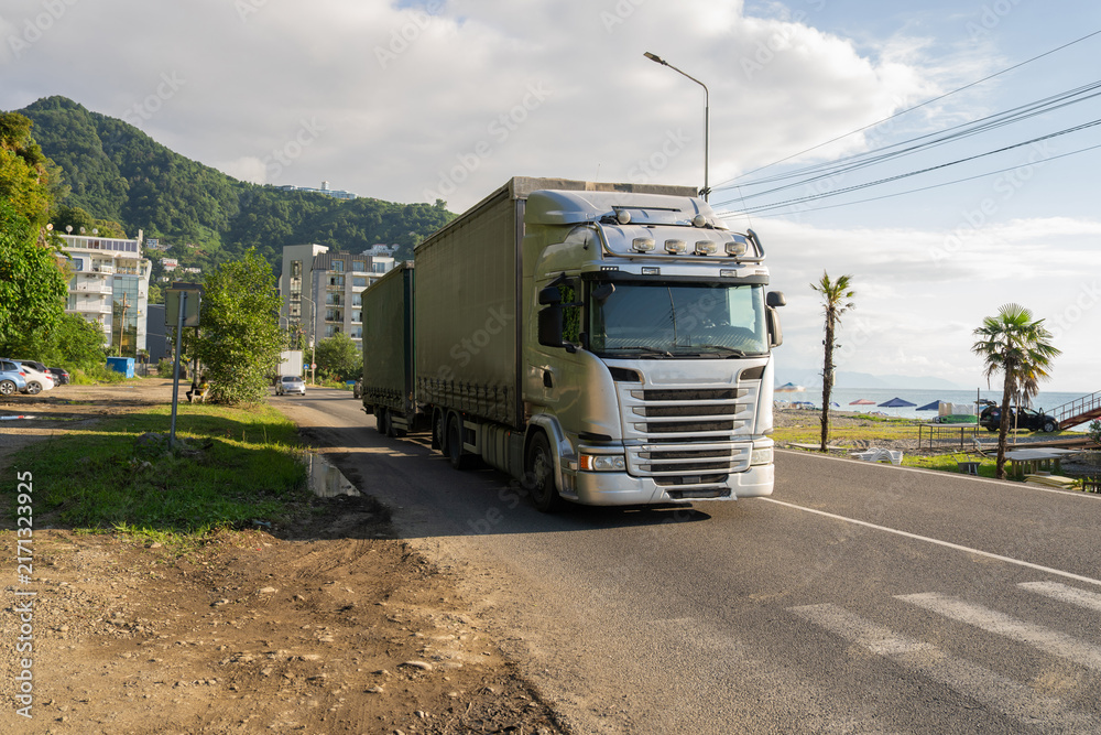 Obraz premium A truck is driving along the road