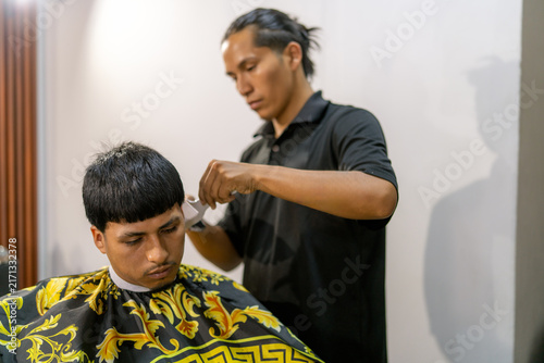 Barber giving client a fresh haircut
