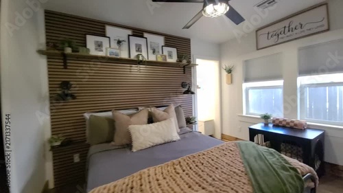 Cozy modern bedroom with quilted bed and warm light