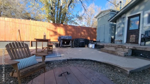 Cozy backyard patio with blue cushions and wooden furniture