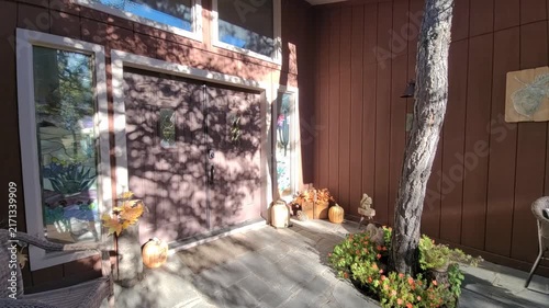 Sunny autumn porch with pumpkins and cozy seating