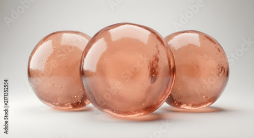 Three elegant rose gold glass spheres with bubbles 3d render abstract background