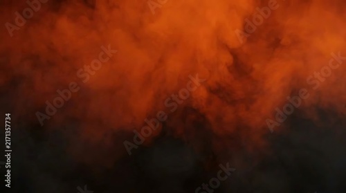 An abstract swirling cloud of orange smoke against a dark background, creating a sense of mystery and energy