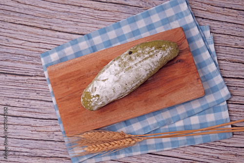Photography Fresh sourdough dusted with flour sits on wooden board