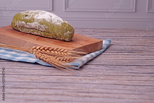 Konstfotografi Fresh sourdough dusted with flour sits on wooden board
