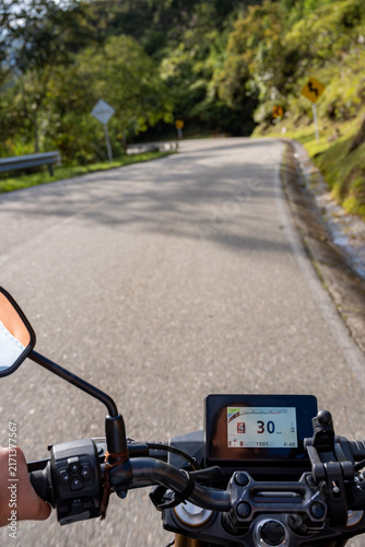 Riding motorcycle on winding mountain road, a scenic nature trip and journey providing a sense of freedom, exploring new destinations and enjoying the adventure