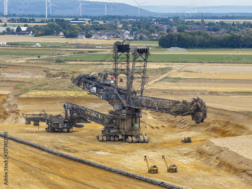 Aerial view of Garzweiler surface mine with a massive bucket-wheel excavator in the open-pit landscape Juechen, North Rhine-Westphalia, Germany.