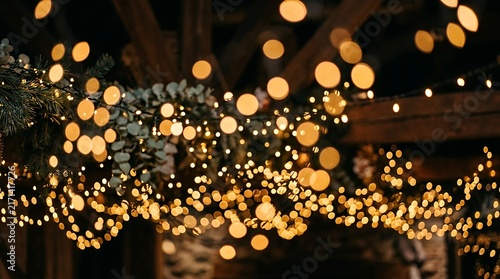 Glittering amber party illumination effects showcasing magical circular unfocused soft light spots creating an elegant seasonal backdrop warm golden bokeh lights festive sparkling background holiday