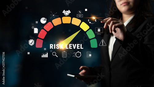 Fotografía Professional Woman Analyzing Risk Levels on a Digital Meter with Icons for Finance, Business, and Data Concepts in a Corporate Environment Quark