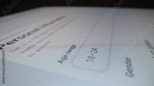 Motorized moving shot of completing demographic information form on tablet