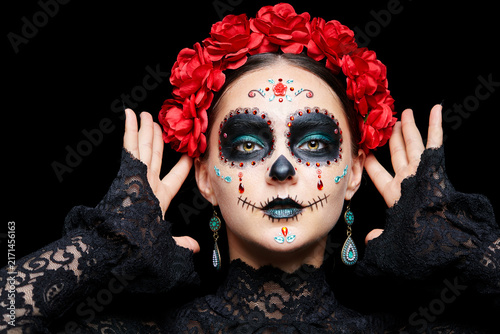 Halloween beauty portrait of woman. Beautiful female face adorned with Santa Muerte makeup.