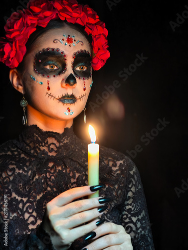 Halloween beauty close-up portrait of woman. Beautiful female face adorned with Santa Muerte makeup.