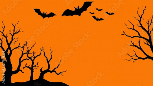 Black bats flying over spooky bare trees against an orange halloween background