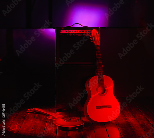 music concert colorful background with electric guitar acoustic guitar and amplifier with free space for text