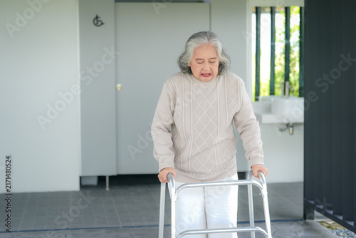 Bild auf Leinwand Senior woman walker restroom accessibility mobility pain healthcare rehabilitati