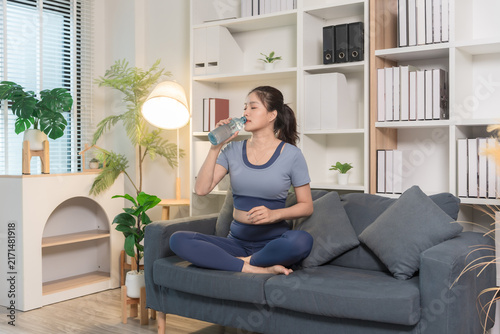 A sporty woman in sportswear exercises at home	