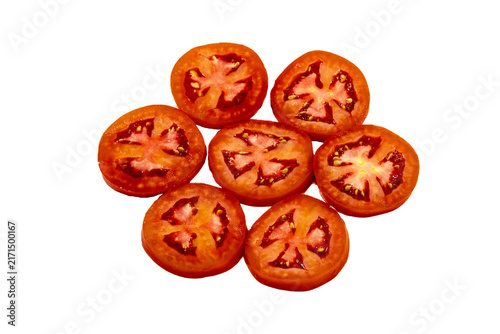Obraz na płótnie Seven circular slices of fresh red tomato arranged in a cluster on a light yello