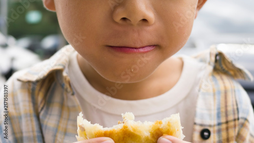 Foto Chinese kid eating local specialty Duijia, a traditional Chinese snack from Jingpeng Town, Hexigten Banner, Inner Mongolia