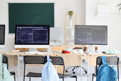Desks with computer monitors in school computer lab
