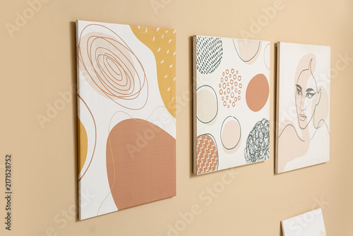 Beautiful paintings on beige wall in art gallery
