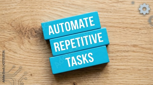 Blue wooden blocks displaying text about automate repetitive tasks on a textured light wooden table surface