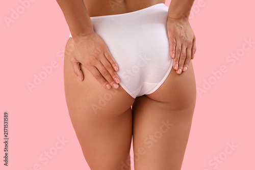 Beautiful young African-American woman with stretch marks on her body against...
