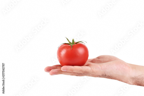Fotografie Ripe red tomato held in an open palm of a hand