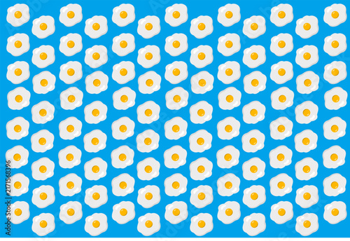 Background pattern featuring vibrant blue circles with bright yellow egg yolk shapes.