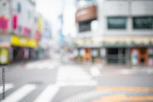 Abstract blurred urban local neighborhood street background with crosswalk markings and buildings