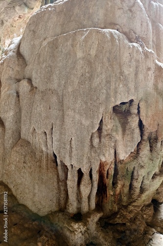 Stalactites hang from a limestone cave ceiling creating a natural wonder.