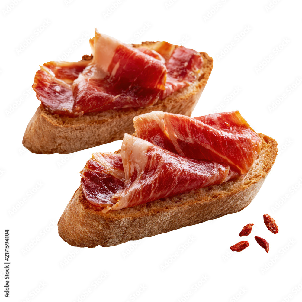 Obraz premium Jamon tapas served on two slices of crusty bread isolated against a plain background