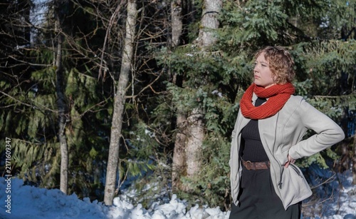 Young woman waiting near a snow-covered forest